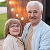 Happy senior man and woman holding by hands in front of camera - Mortgages In Reverse | Ontario Reverse Mortgage Experts