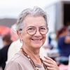 Senior woman at the flea market looking for second hand clothes - Mortgages In Reverse | Ontario Reverse Mortgage Experts