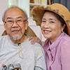 Senior woman holding digital camera taking photos of husband at home - Mortgages In Reverse | Ontario Reverse Mortgage Experts